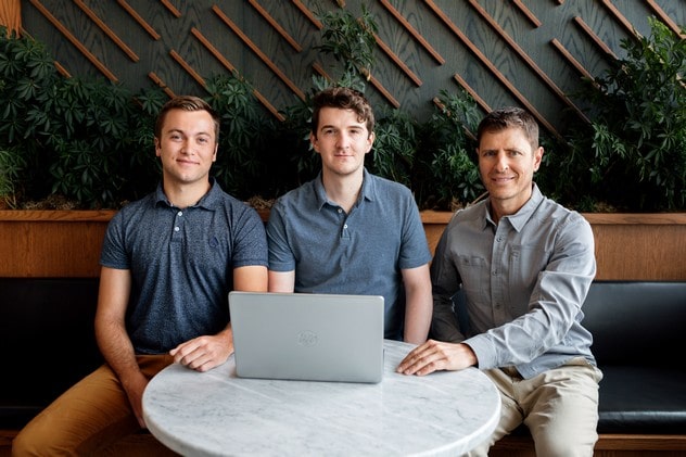 Grounds for Promotion team of three photo in office at table